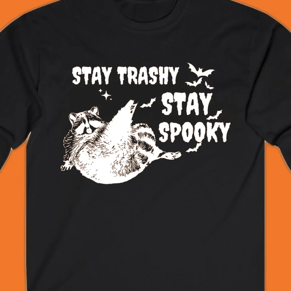 Trashy spooky raccoon illustration with bats and text for Halloween.