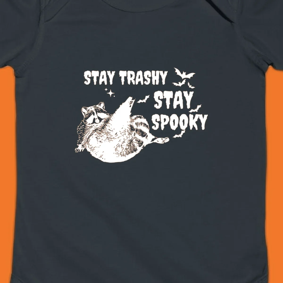 Trashy spooky raccoon illustration with bats and text for Halloween.
