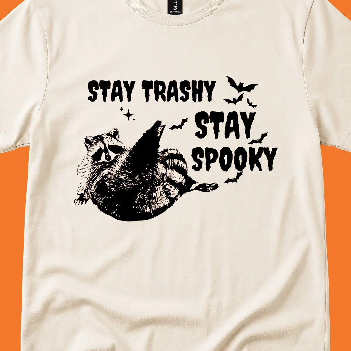 Trashy spooky raccoon illustration with bats and text for Halloween.
