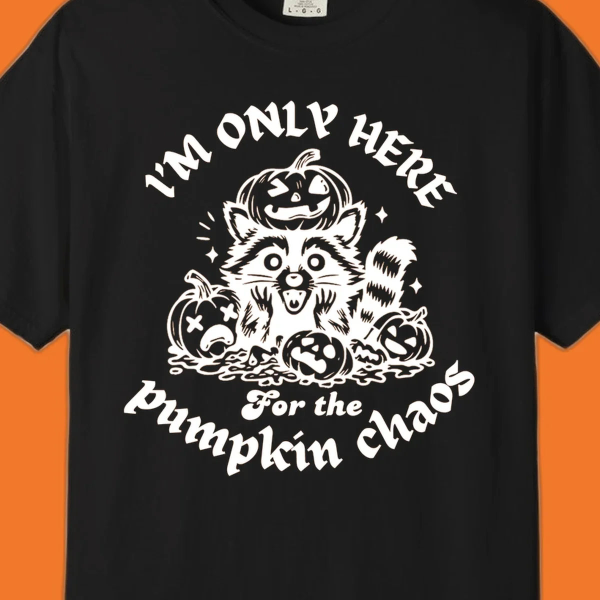 Illustration of a raccoon surrounded by pumpkins, text says 'I'm Only Here For The Pumpkin Chaos'.