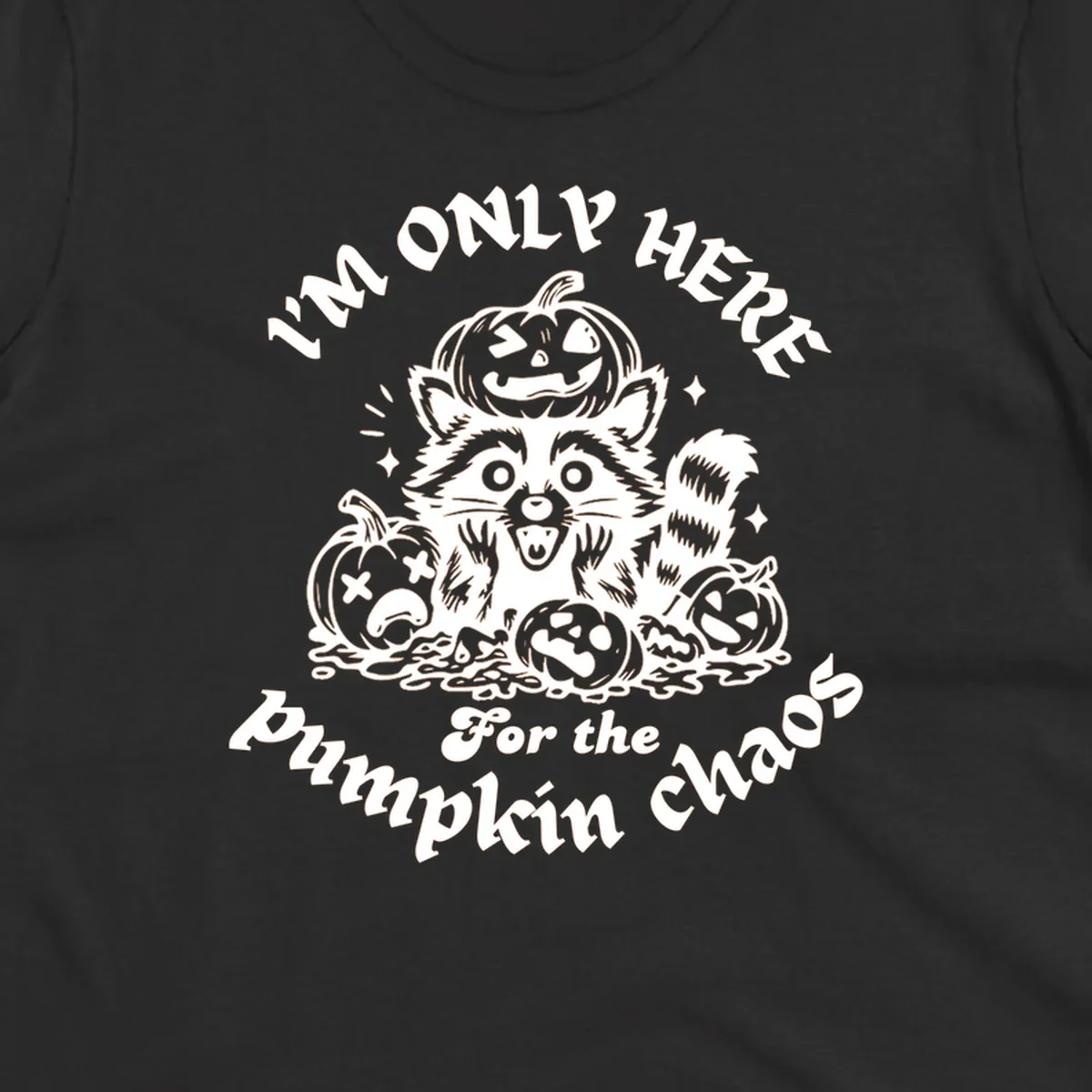Illustration of a raccoon surrounded by pumpkins, text says 'I'm Only Here For The Pumpkin Chaos'.