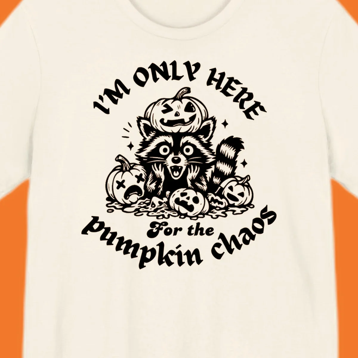 Illustration of a raccoon surrounded by pumpkins, text says 'I'm Only Here For The Pumpkin Chaos'.
