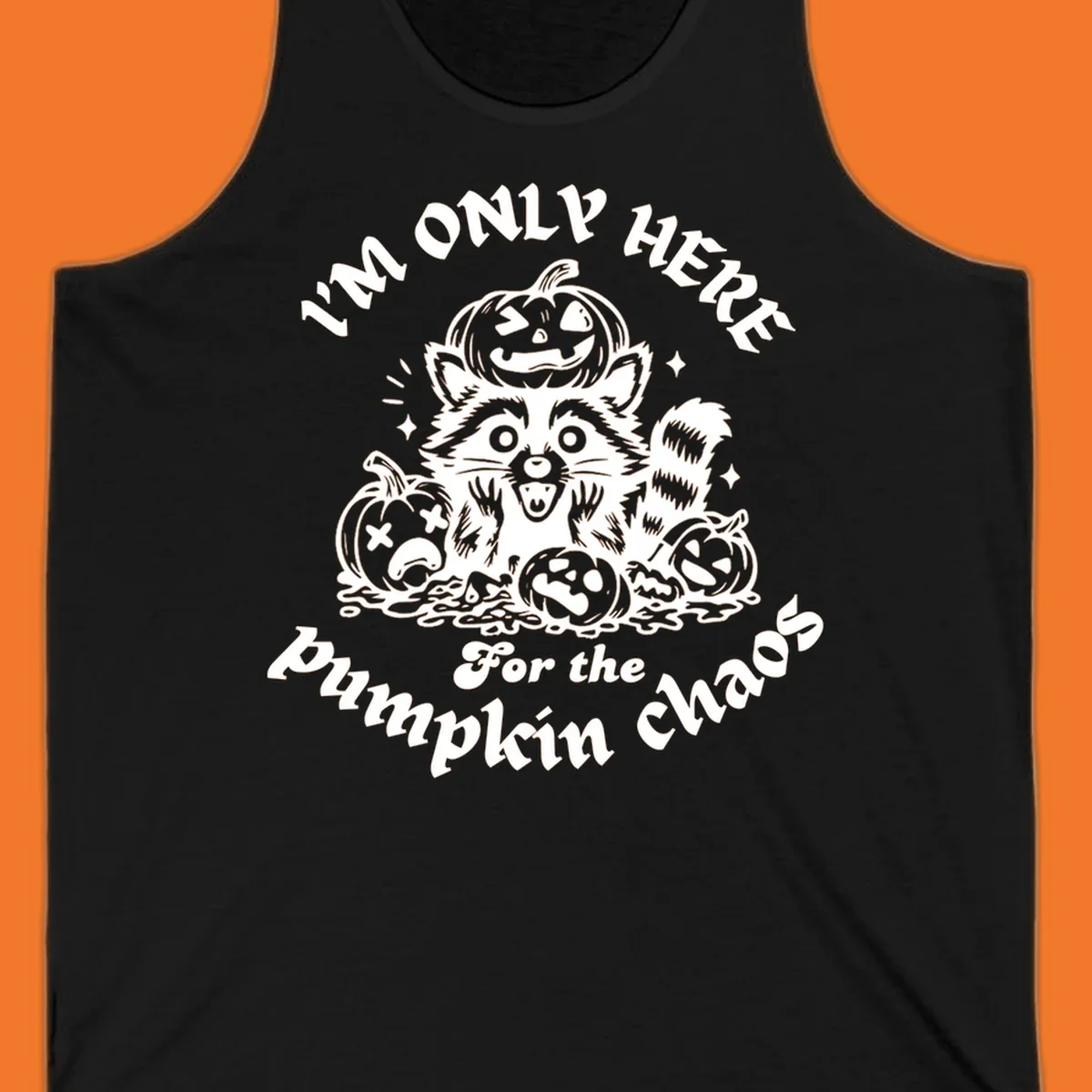 Illustration of a raccoon surrounded by pumpkins, text says 'I'm Only Here For The Pumpkin Chaos'.