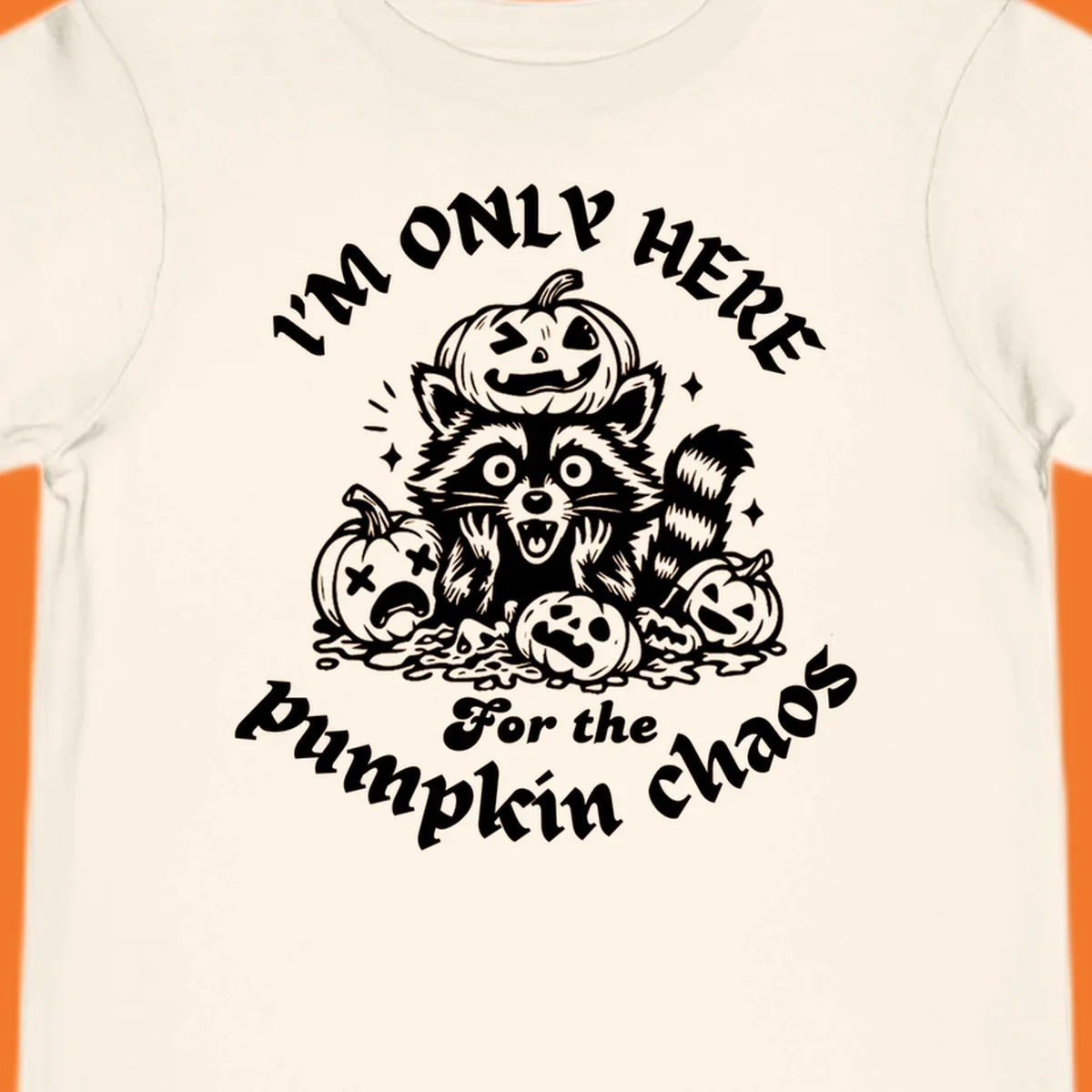 Illustration of a raccoon surrounded by pumpkins, text says 'I'm Only Here For The Pumpkin Chaos'.