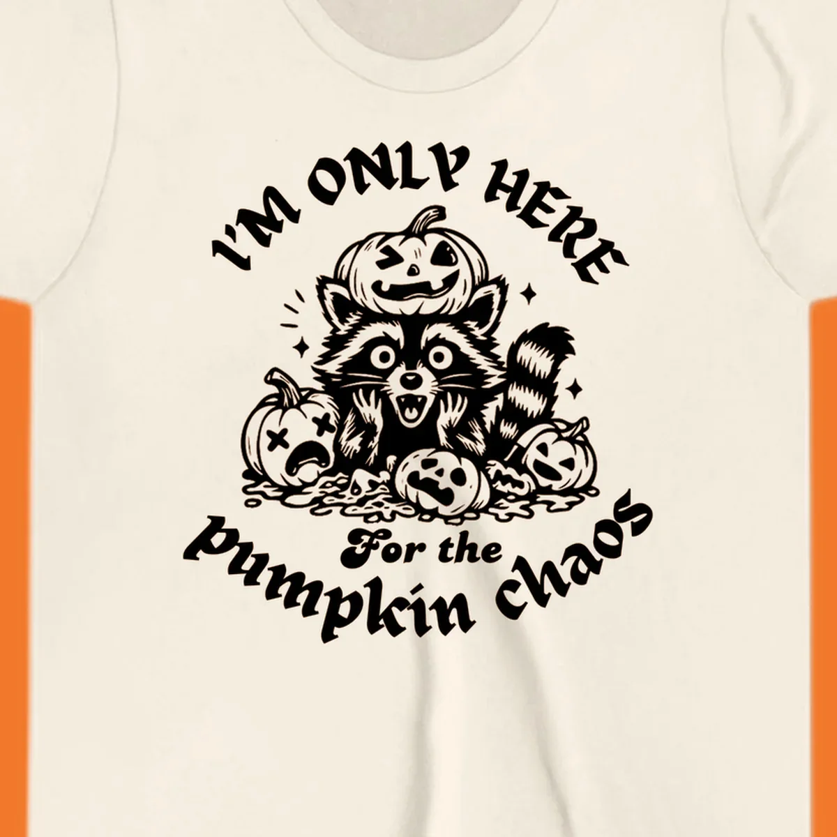 Illustration of a raccoon surrounded by pumpkins, text says 'I'm Only Here For The Pumpkin Chaos'.