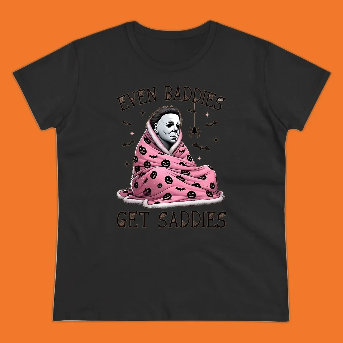Michael Myers in a pink pumpkin blanket with text 'EVEN BADDIES GET SADDIES', for the michael-myers-cozy concept.