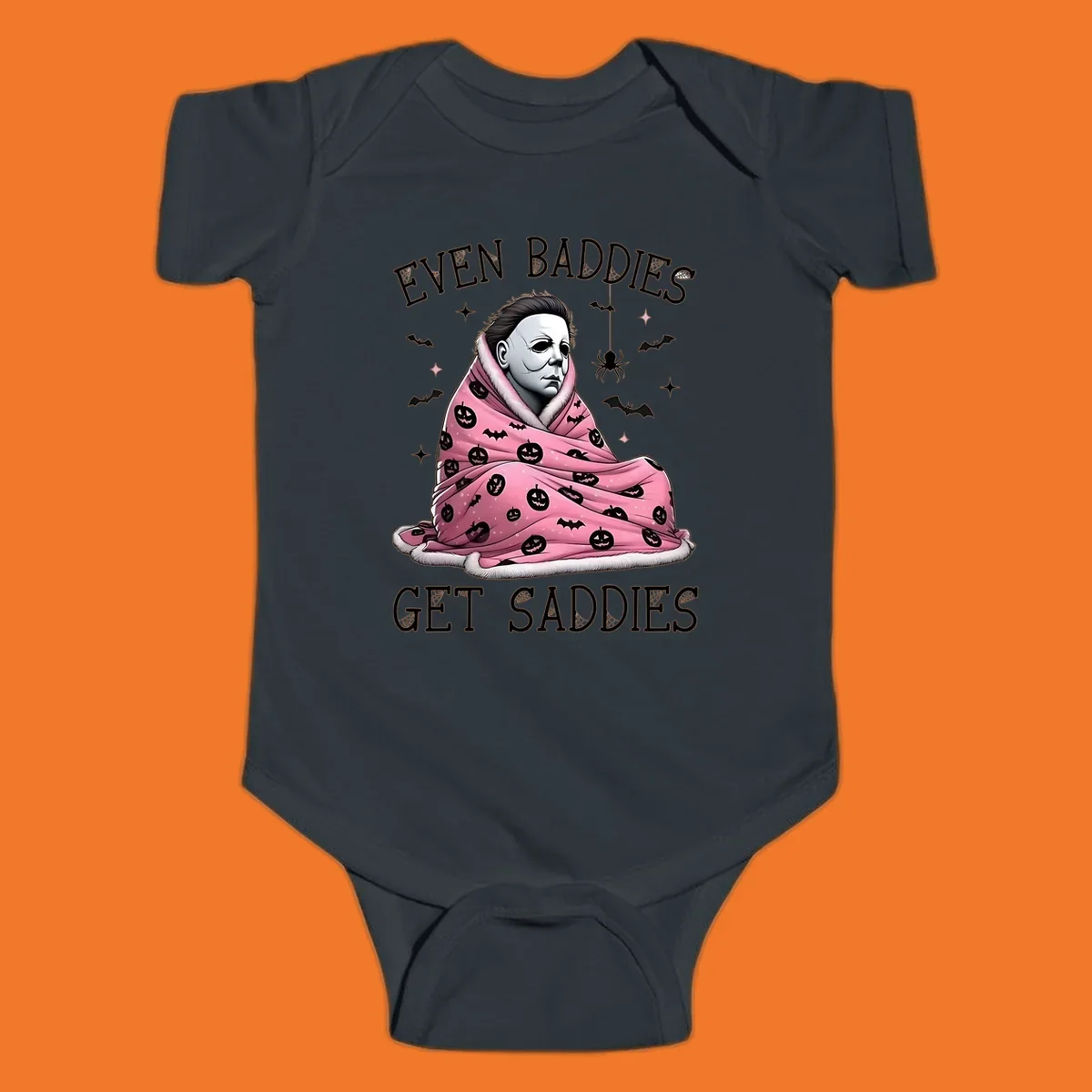 Michael Myers in a pink pumpkin blanket with text 'EVEN BADDIES GET SADDIES', for the michael-myers-cozy concept.