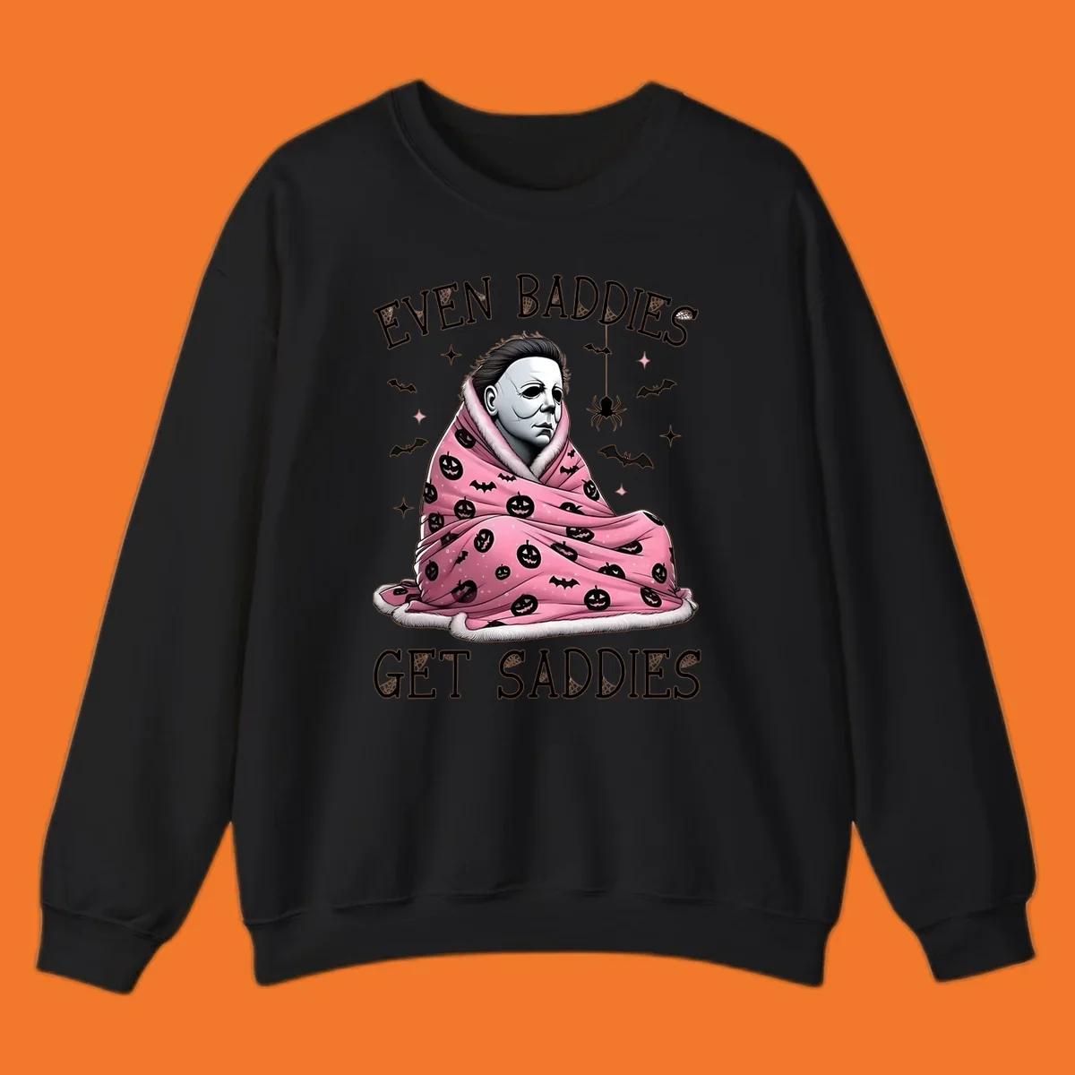 Michael Myers in a pink pumpkin blanket with text 'EVEN BADDIES GET SADDIES', for the michael-myers-cozy concept.