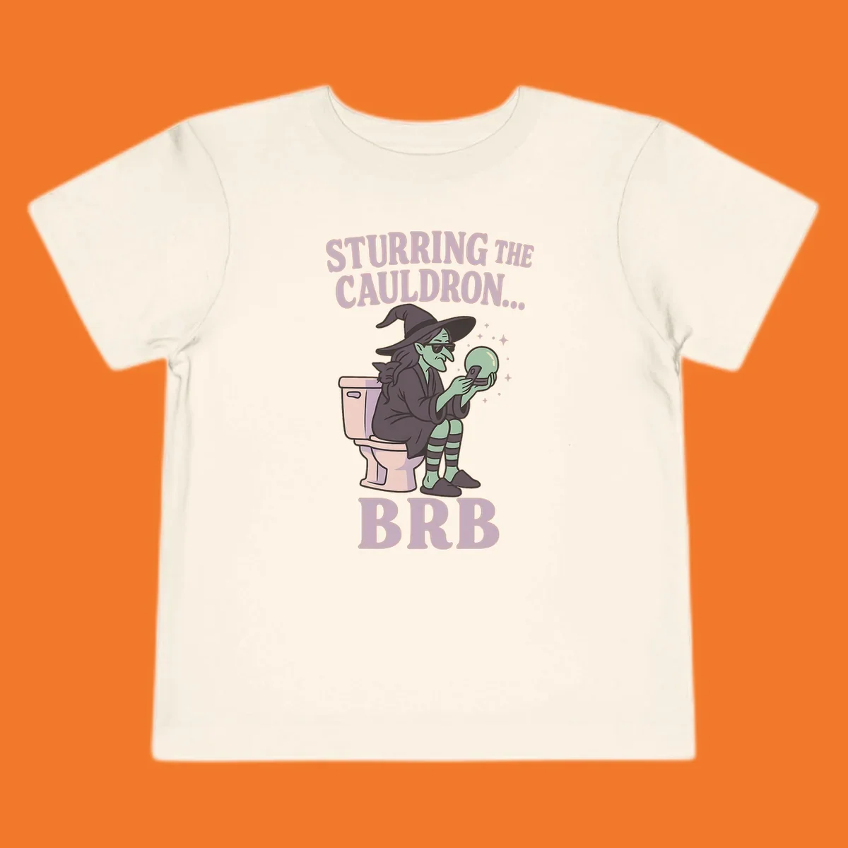 Funny witch on toilet looking at phone with crystal ball, text says Stirring the Cauldron... BRB