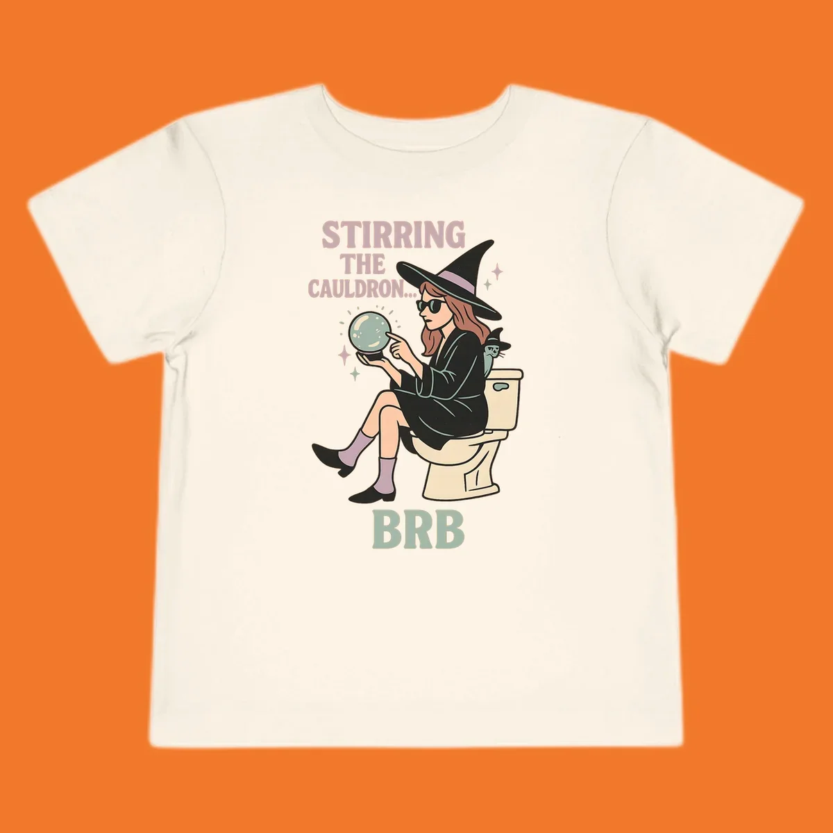 Witch sitting on toilet with crystal ball, text says Stirring The Cauldron BRB.