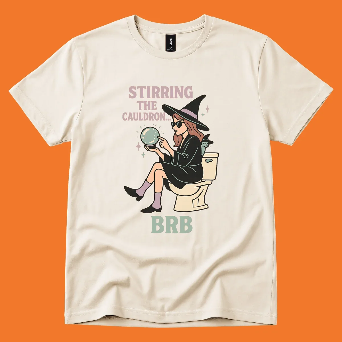 Witch sitting on toilet with crystal ball, text says Stirring The Cauldron BRB.