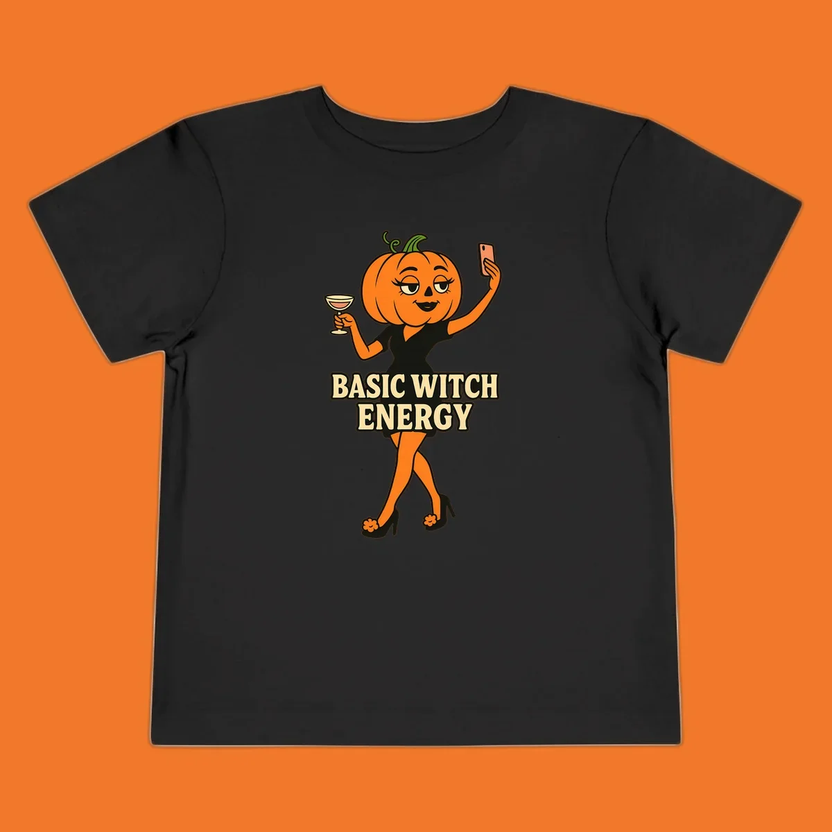 Pumpkin character with 'BASIC WITCH ENERGY' text, holding a cocktail and phone for a selfie.