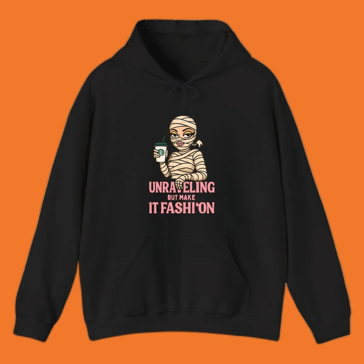 Mummy holding coffee cup with 'Unraveling But Make It Fashion' text. Mummy-fashion-coffee.