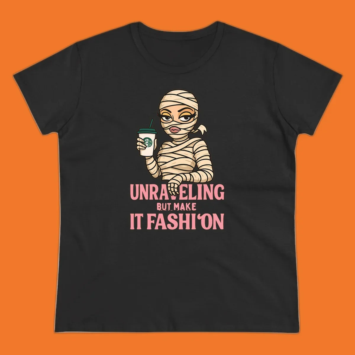 Mummy holding coffee cup with 'Unraveling But Make It Fashion' text. Mummy-fashion-coffee.