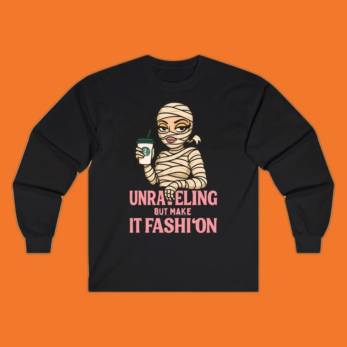 Mummy holding coffee cup with 'Unraveling But Make It Fashion' text. Mummy-fashion-coffee.