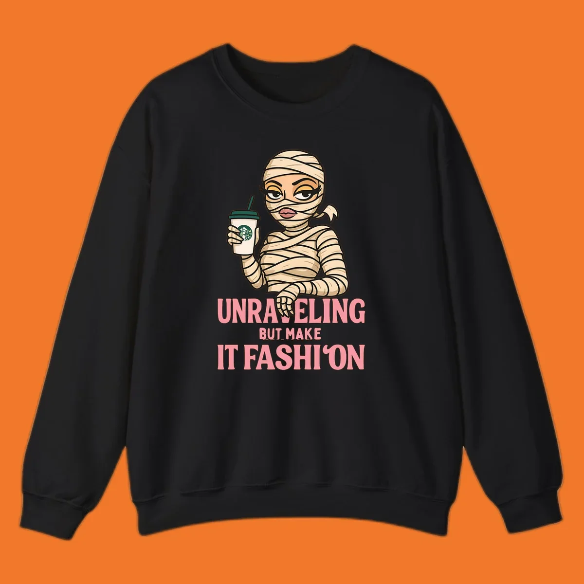 Mummy holding coffee cup with 'Unraveling But Make It Fashion' text. Mummy-fashion-coffee.