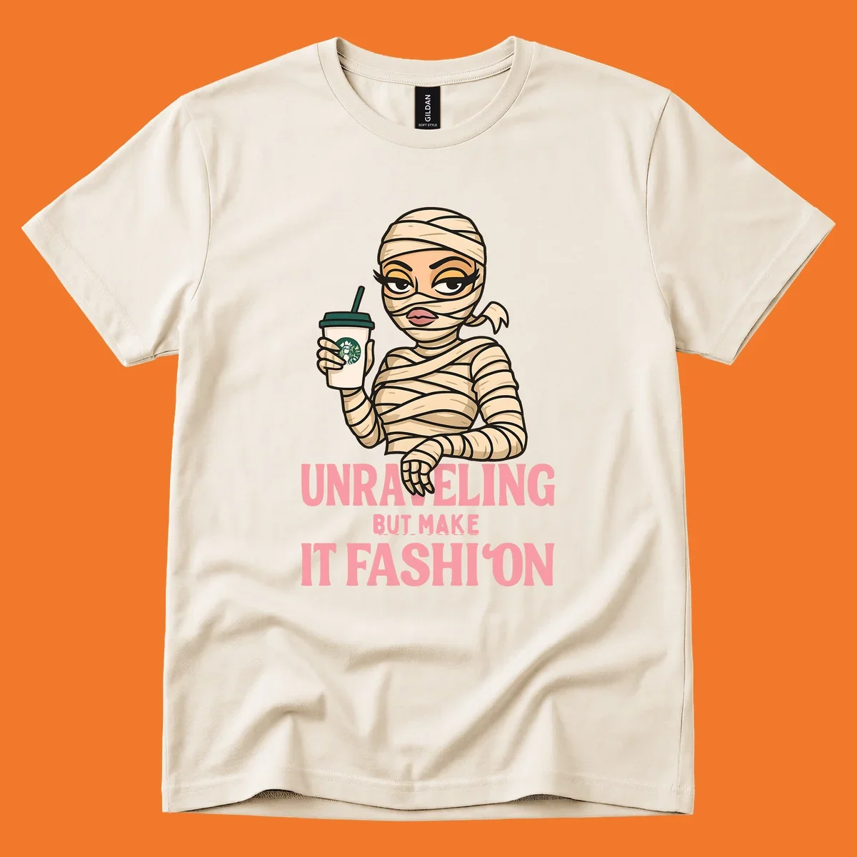 Mummy holding coffee cup with 'Unraveling But Make It Fashion' text. Mummy-fashion-coffee.