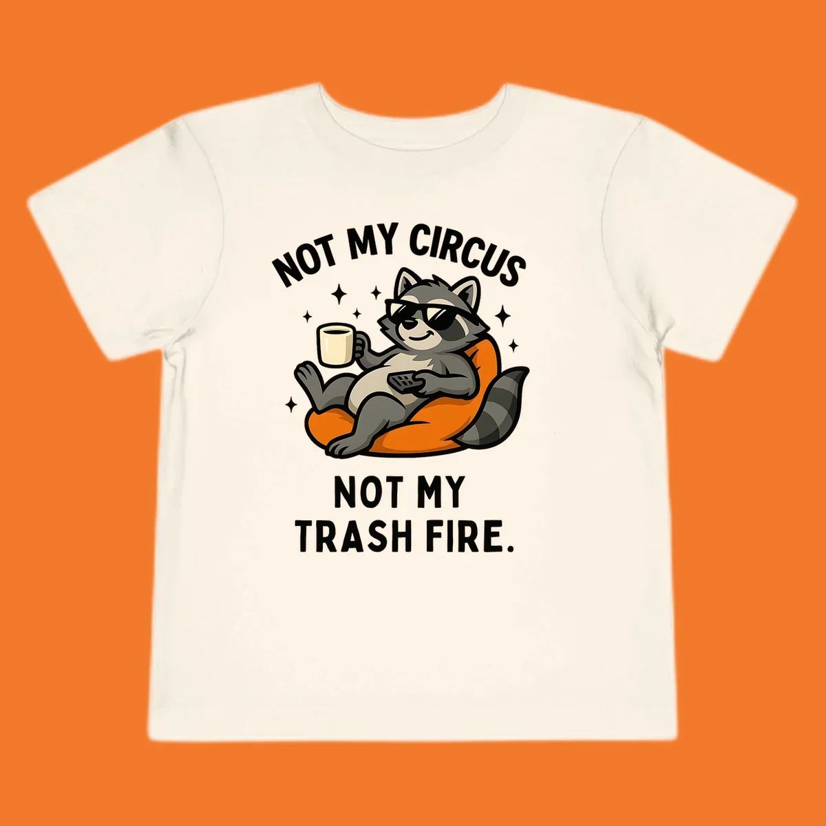 Illustration of a raccoon in sunglasses relaxing with coffee and remote, text 'Not My Circus Not My Trash Fire'.