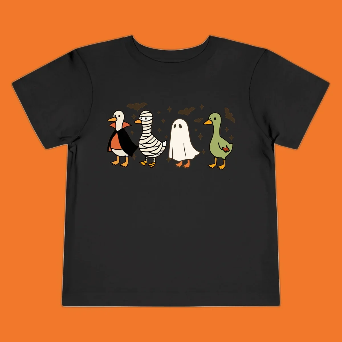 Four cute ducks in Halloween costumes: vampire, mummy, ghost, and plain duck, with bats and stars.