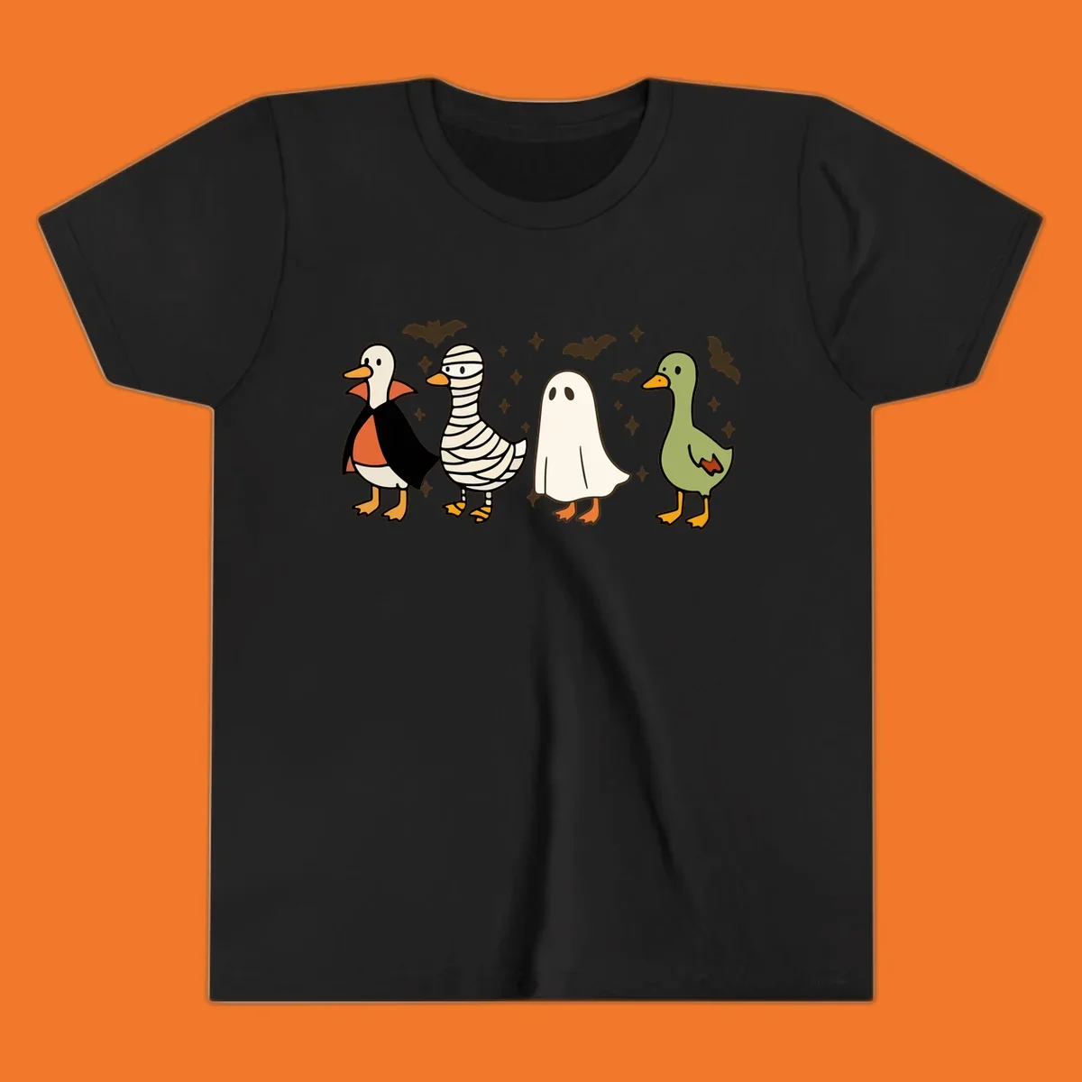 Four cute ducks in Halloween costumes: vampire, mummy, ghost, and plain duck, with bats and stars.