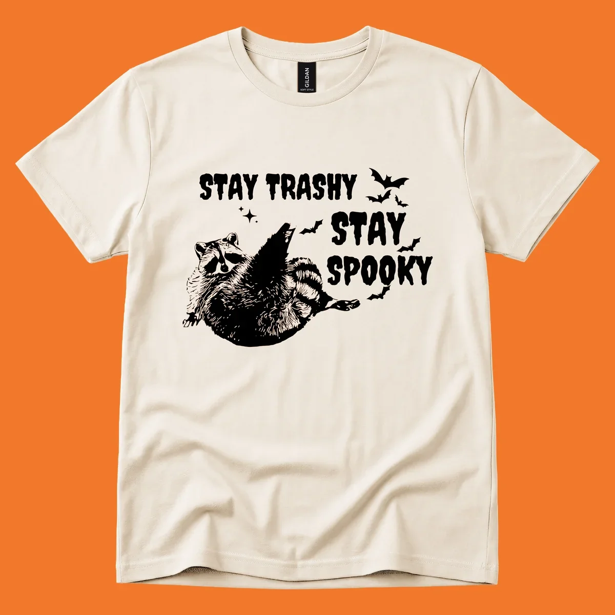 Trashy spooky raccoon illustration with bats and text for Halloween.