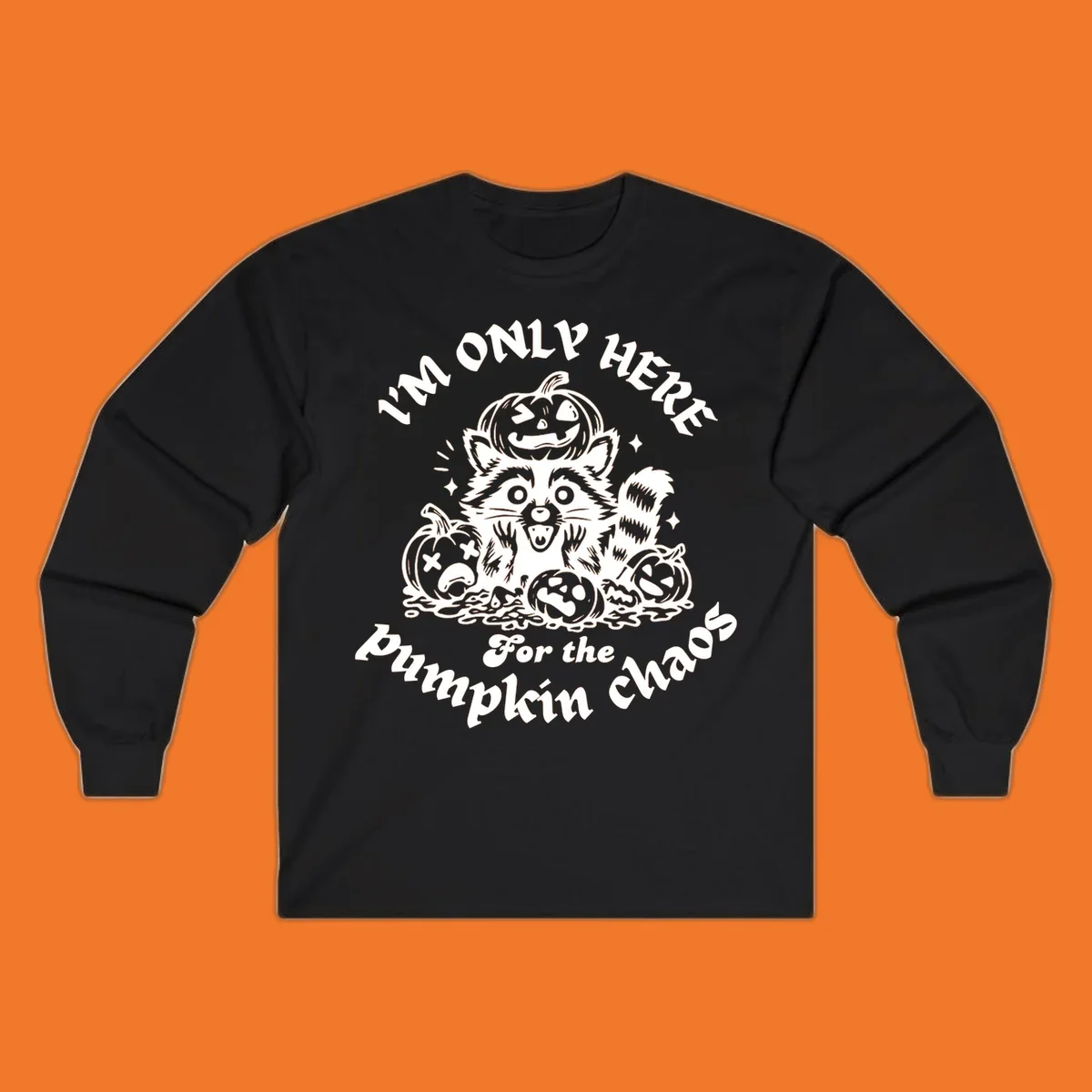 Illustration of a raccoon surrounded by pumpkins, text says 'I'm Only Here For The Pumpkin Chaos'.