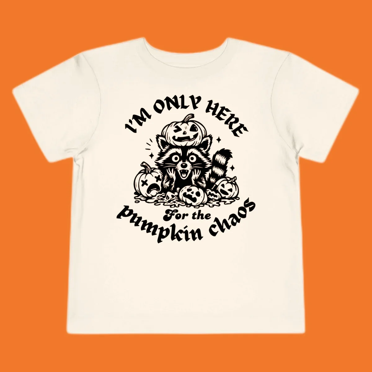 Illustration of a raccoon surrounded by pumpkins, text says 'I'm Only Here For The Pumpkin Chaos'.