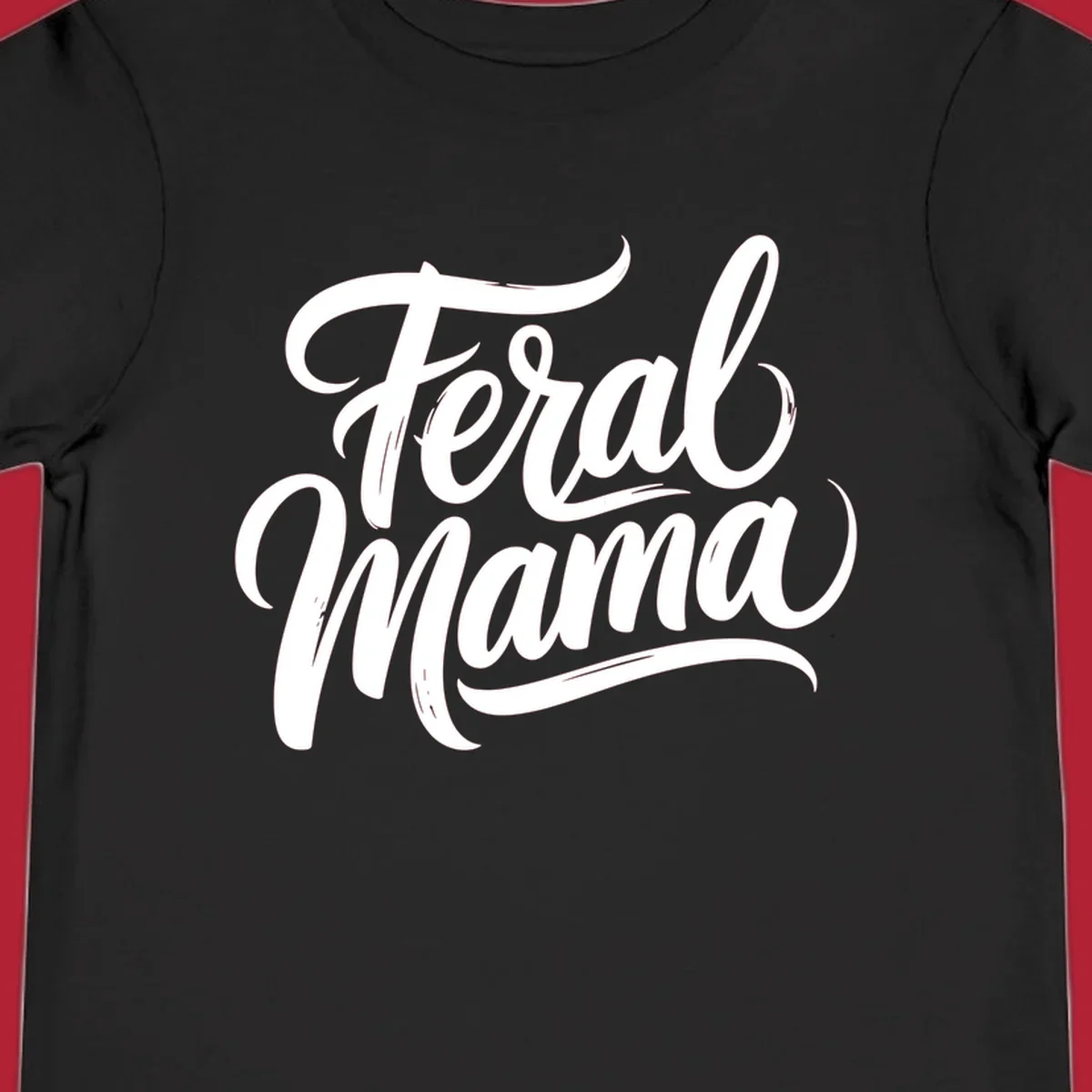 Bold black script text reading 'Feral Mama' with decorative flourishes, highlighting the feral mama script concept.