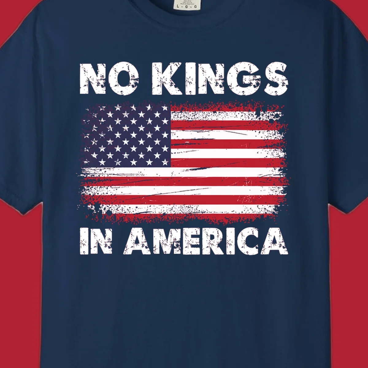 A distressed American flag with the white text 'NO KINGS IN AMERICA' above and below it.