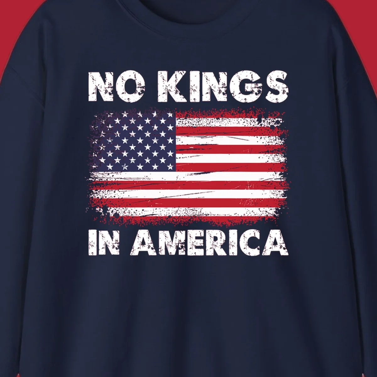 A distressed American flag with the white text 'NO KINGS IN AMERICA' above and below it.