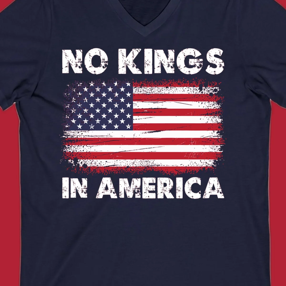 A distressed American flag with the white text 'NO KINGS IN AMERICA' above and below it.