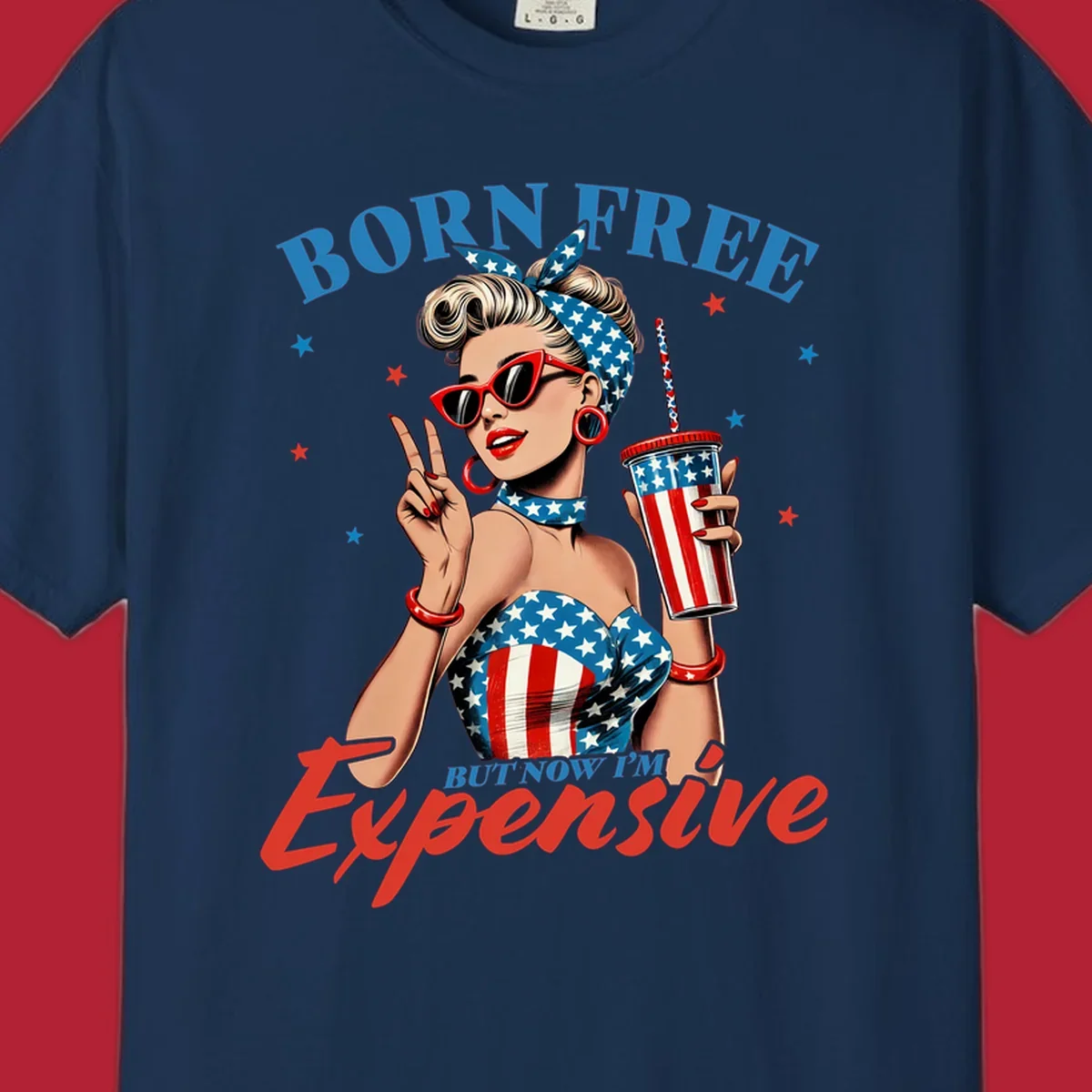 A vintage pin-up girl with a patriotic outfit and cup, making a peace sign, with the text "Born Free But Now I'm Expensive". This born-free-expensive-pinup design is surrounded by stars.