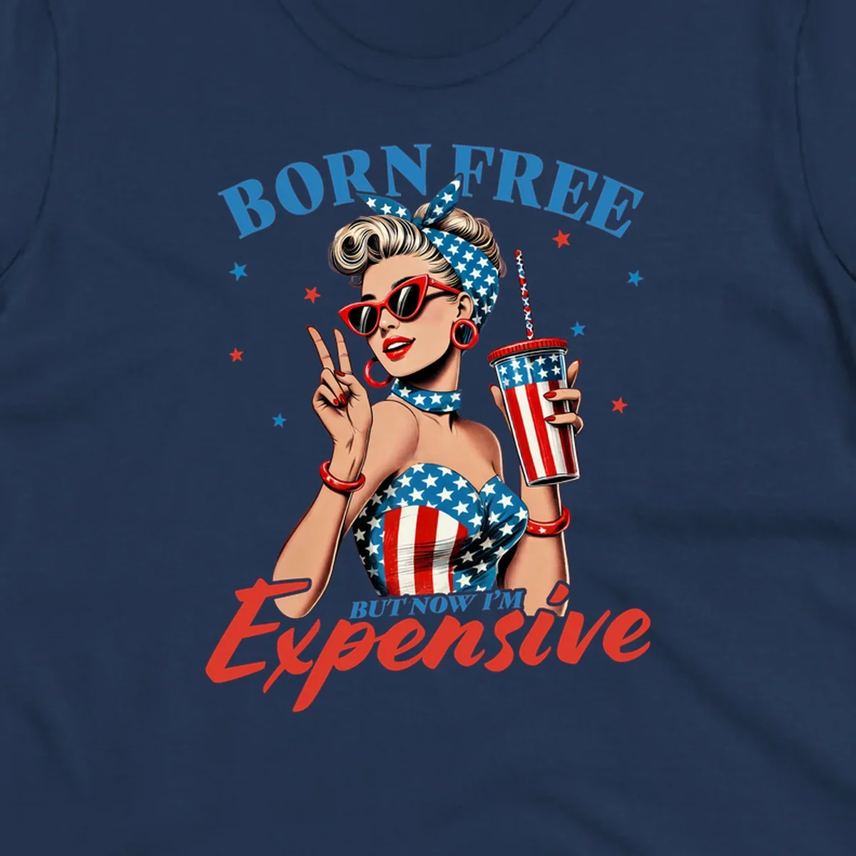 A vintage pin-up girl with a patriotic outfit and cup, making a peace sign, with the text "Born Free But Now I'm Expensive". This born-free-expensive-pinup design is surrounded by stars.