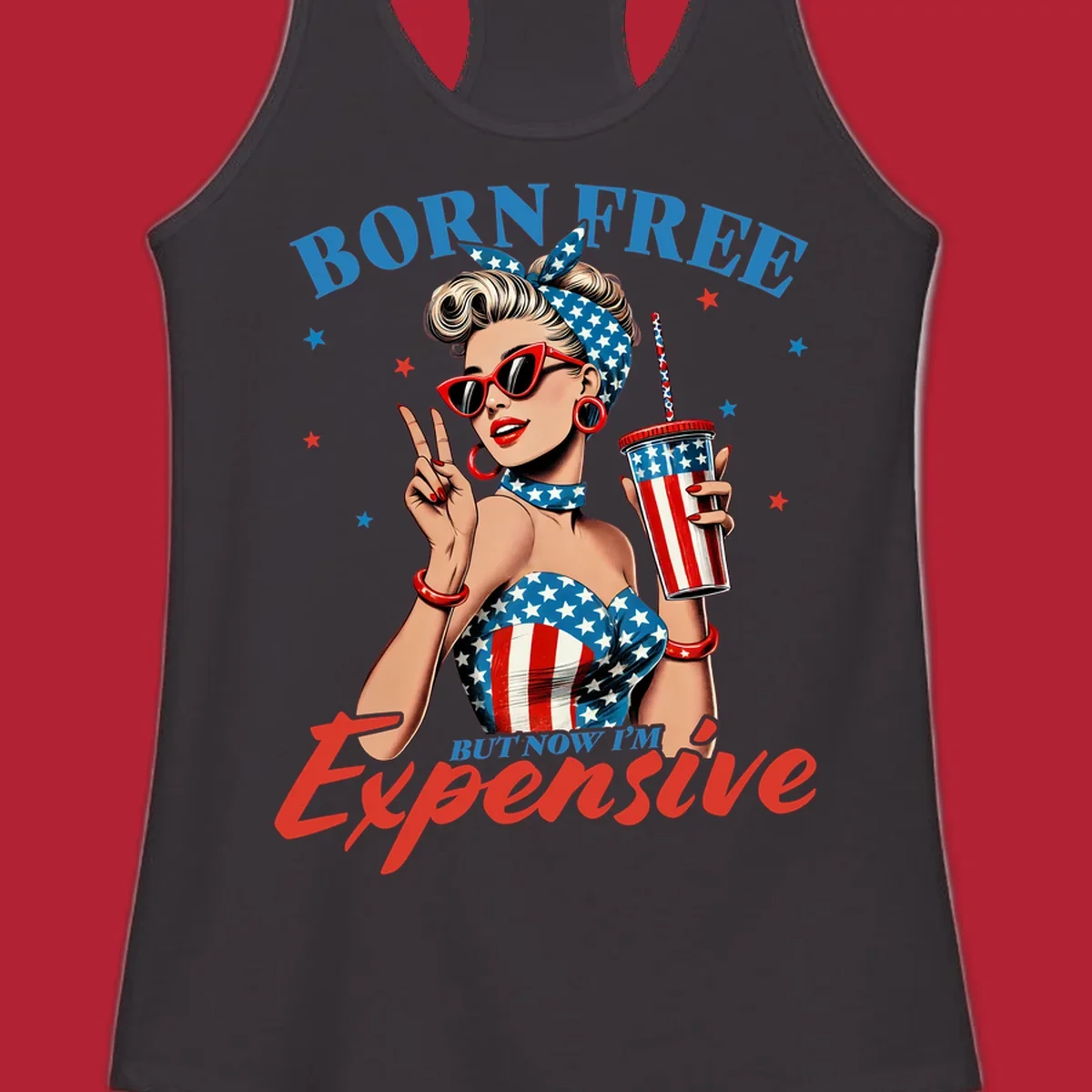 A vintage pin-up girl with a patriotic outfit and cup, making a peace sign, with the text "Born Free But Now I'm Expensive". This born-free-expensive-pinup design is surrounded by stars.