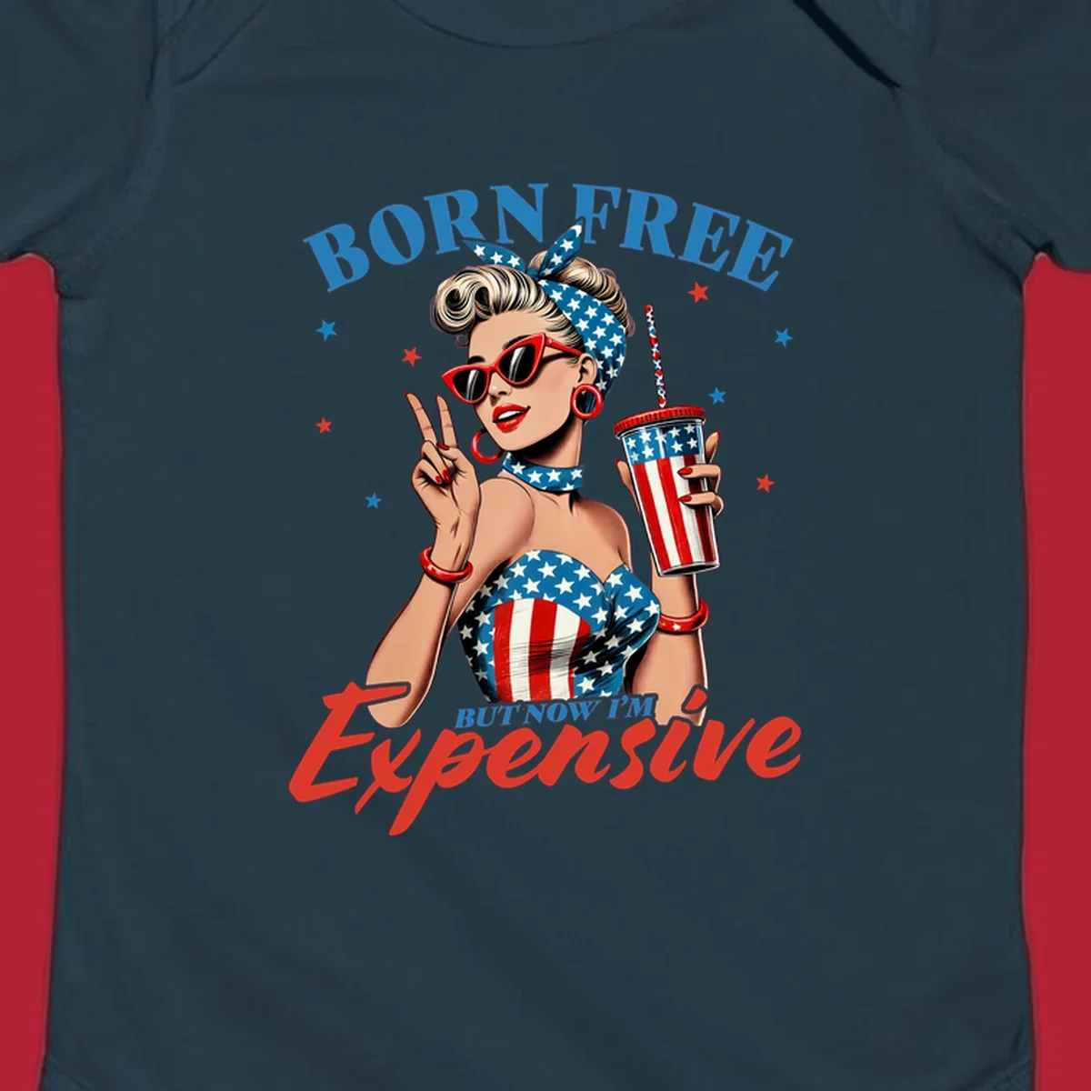 A vintage pin-up girl with a patriotic outfit and cup, making a peace sign, with the text "Born Free But Now I'm Expensive". This born-free-expensive-pinup design is surrounded by stars.