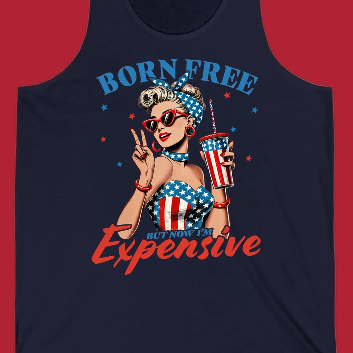 A vintage pin-up girl with a patriotic outfit and cup, making a peace sign, with the text "Born Free But Now I'm Expensive". This born-free-expensive-pinup design is surrounded by stars.
