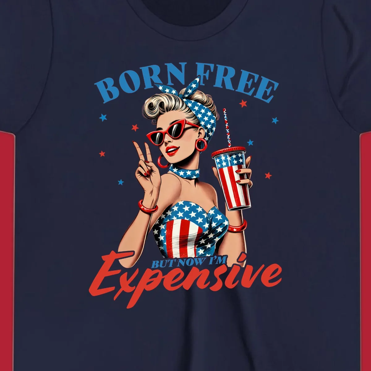 A vintage pin-up girl with a patriotic outfit and cup, making a peace sign, with the text "Born Free But Now I'm Expensive". This born-free-expensive-pinup design is surrounded by stars.