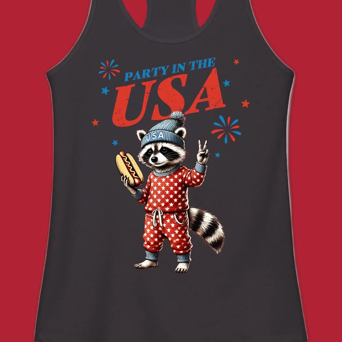 A cartoon raccoon wearing a USA beanie and star-patterned pajamas, holding a hotdog and making a peace sign, with 'PARTY IN THE USA' text and fireworks.