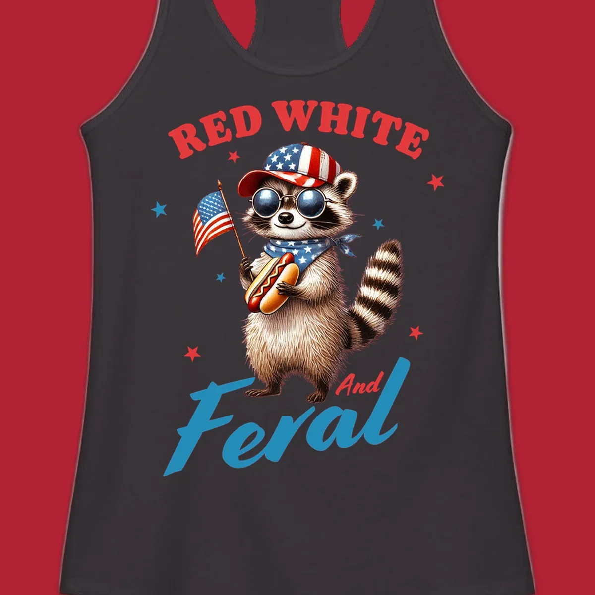 A cartoon raccoon wearing a patriotic hat and bandana, holding an American flag and a hot dog, with 'Red White And Feral' text. This is a red-white-feral-raccoon design.