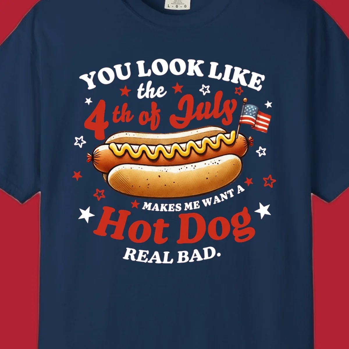 An illustrated hot dog with mustard, American flags, and stars. Text reads "YOU LOOK LIKE the 4th of July MAKES ME WANT A Hot Dog REAL BAD." you-look-like-4th-july design.