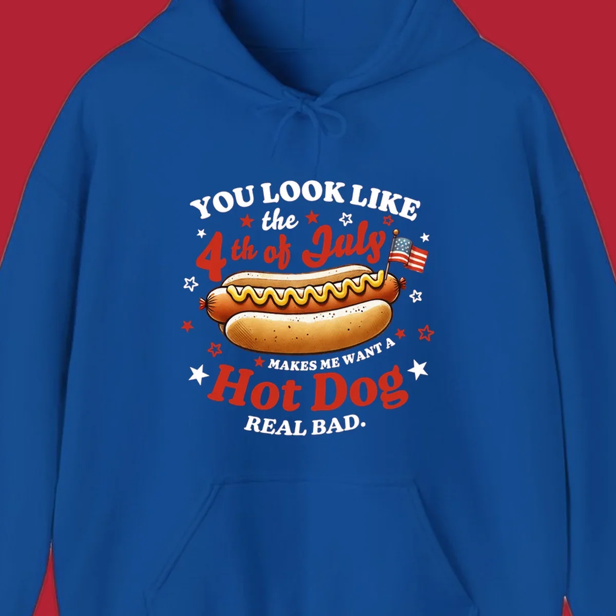 An illustrated hot dog with mustard, American flags, and stars. Text reads "YOU LOOK LIKE the 4th of July MAKES ME WANT A Hot Dog REAL BAD." you-look-like-4th-july design.