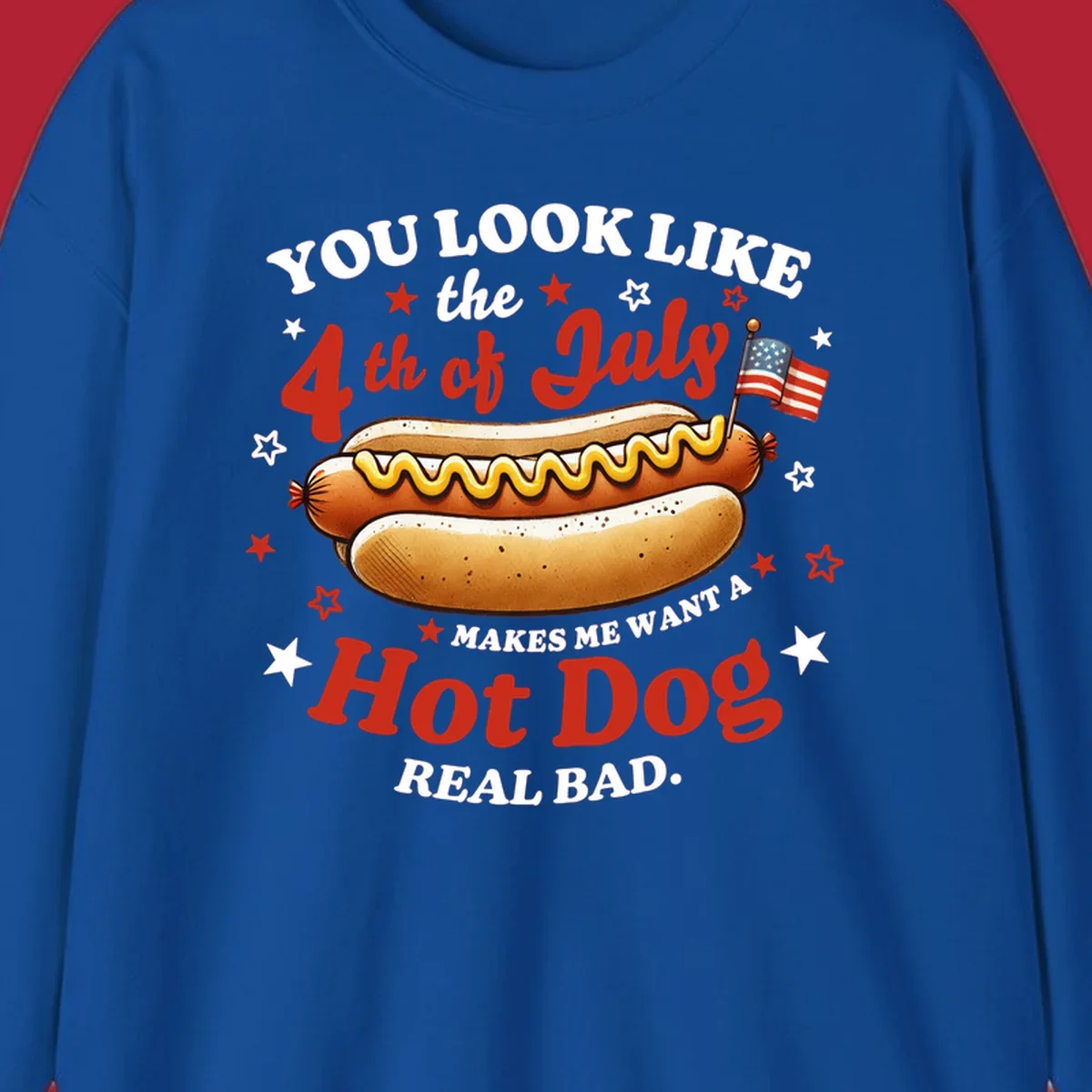 An illustrated hot dog with mustard, American flags, and stars. Text reads "YOU LOOK LIKE the 4th of July MAKES ME WANT A Hot Dog REAL BAD." you-look-like-4th-july design.