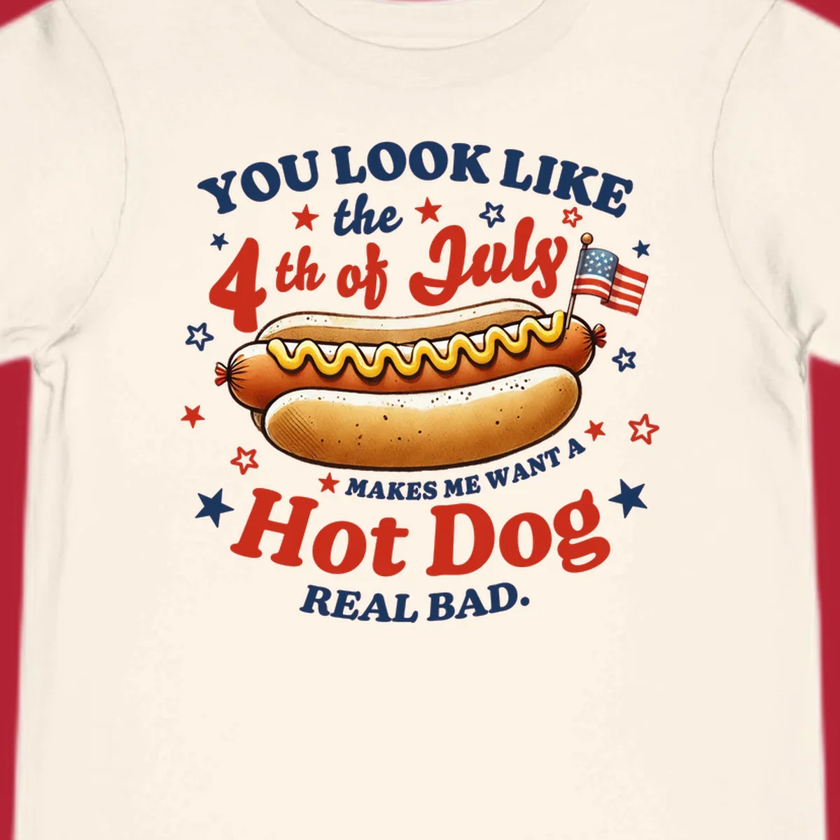 An illustrated hot dog with mustard, American flags, and stars. Text reads "YOU LOOK LIKE the 4th of July MAKES ME WANT A Hot Dog REAL BAD." you-look-like-4th-july design.