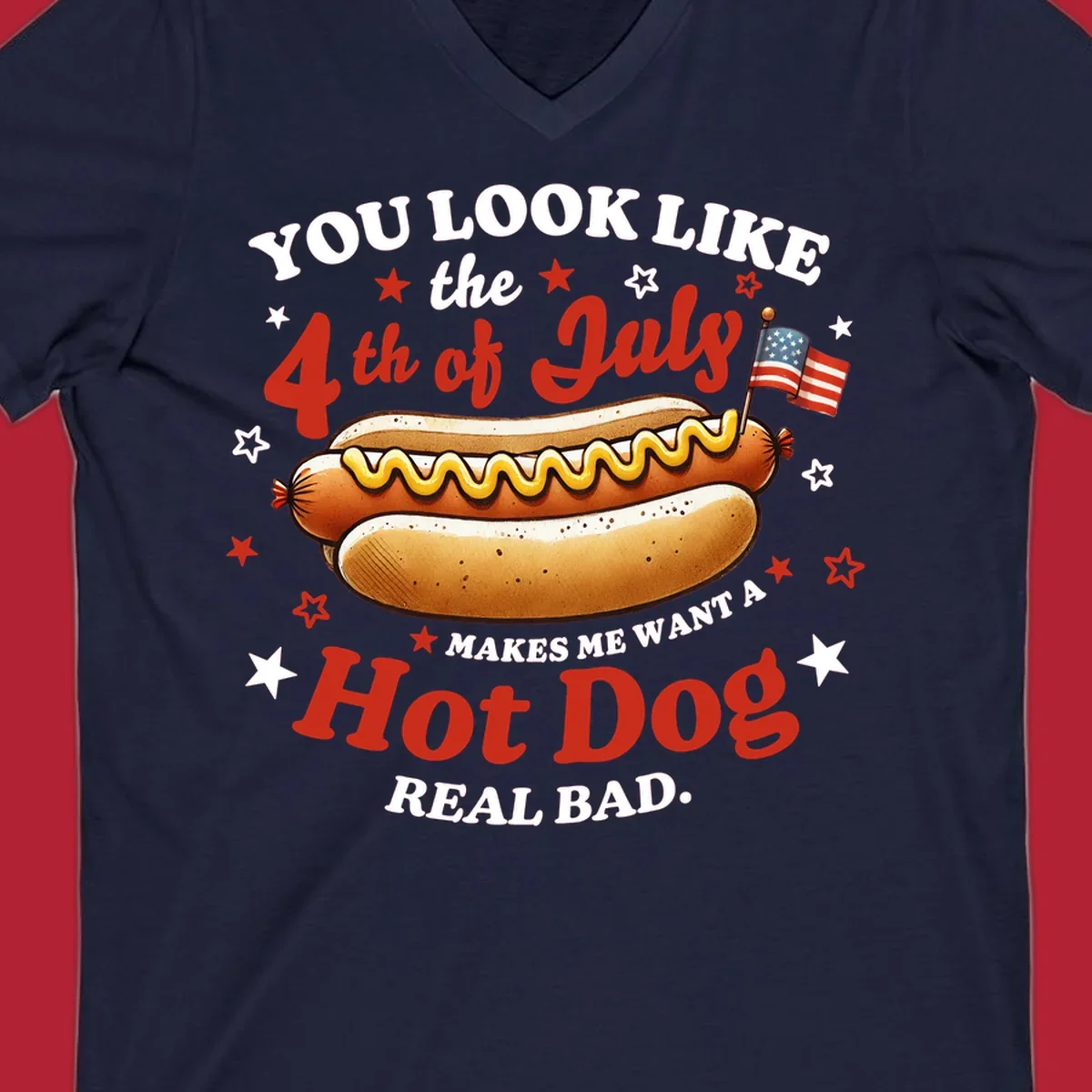 An illustrated hot dog with mustard, American flags, and stars. Text reads "YOU LOOK LIKE the 4th of July MAKES ME WANT A Hot Dog REAL BAD." you-look-like-4th-july design.