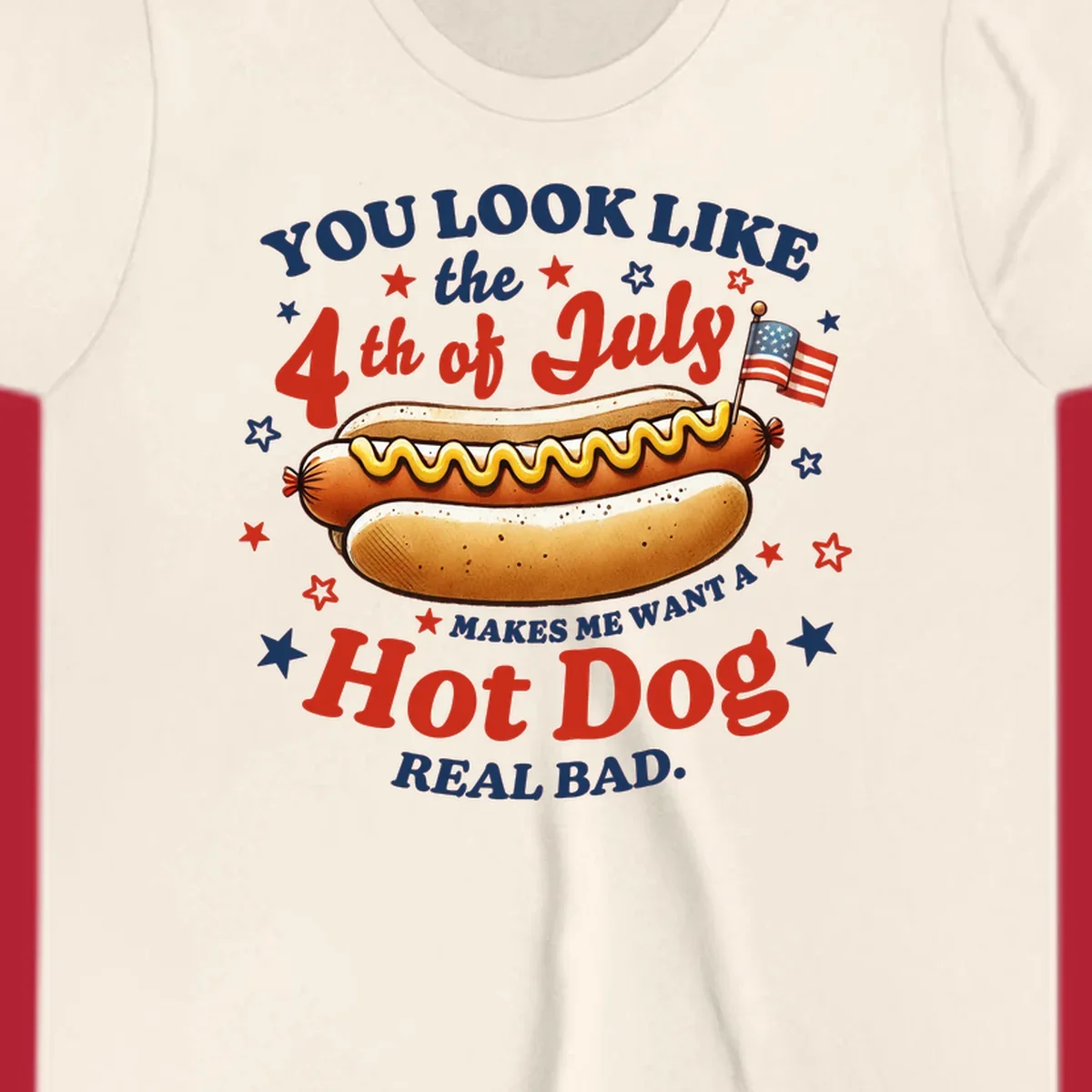 An illustrated hot dog with mustard, American flags, and stars. Text reads "YOU LOOK LIKE the 4th of July MAKES ME WANT A Hot Dog REAL BAD." you-look-like-4th-july design.