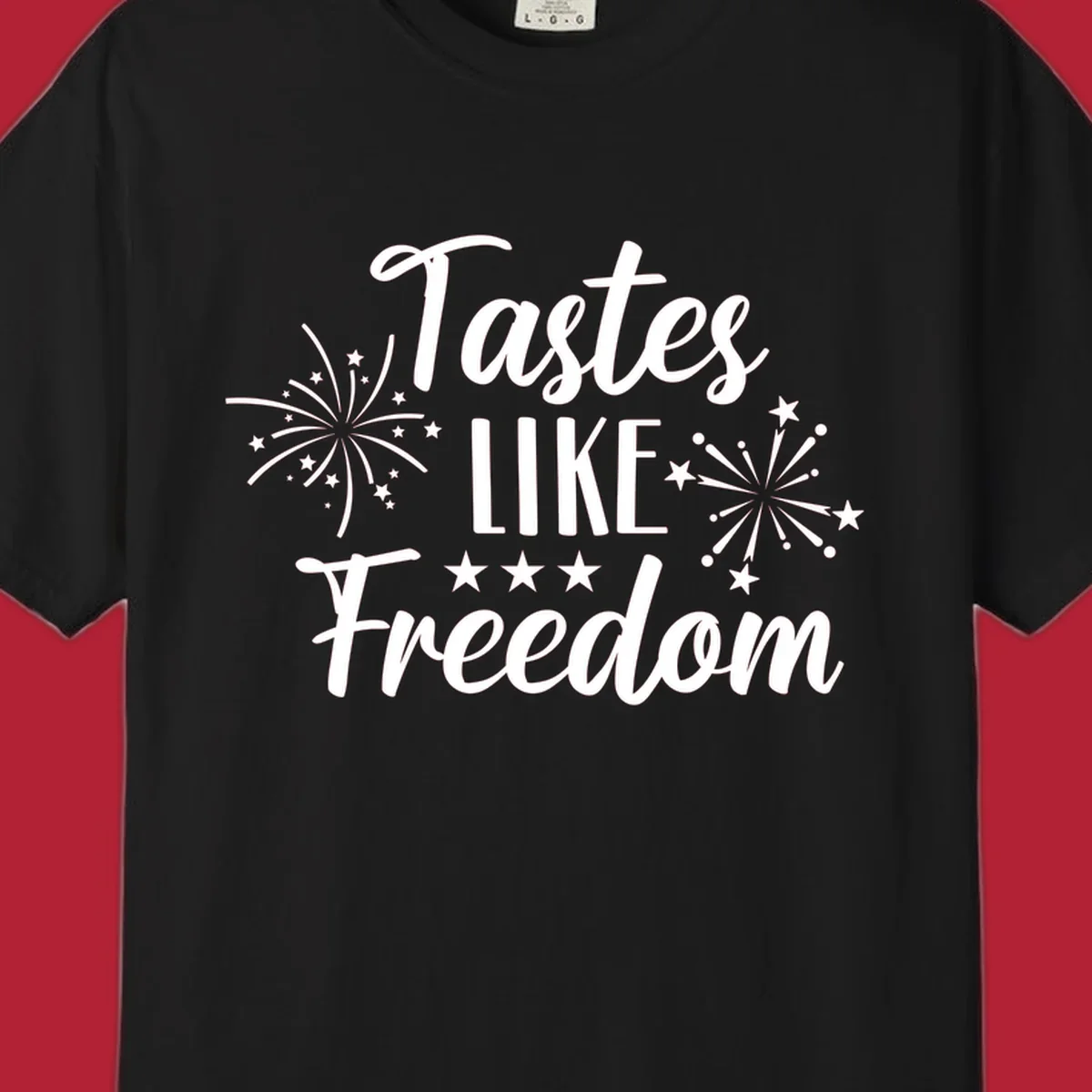 A patriotic design with the phrase 'Tastes LIKE Freedom' in script and block letters, surrounded by fireworks and stars.