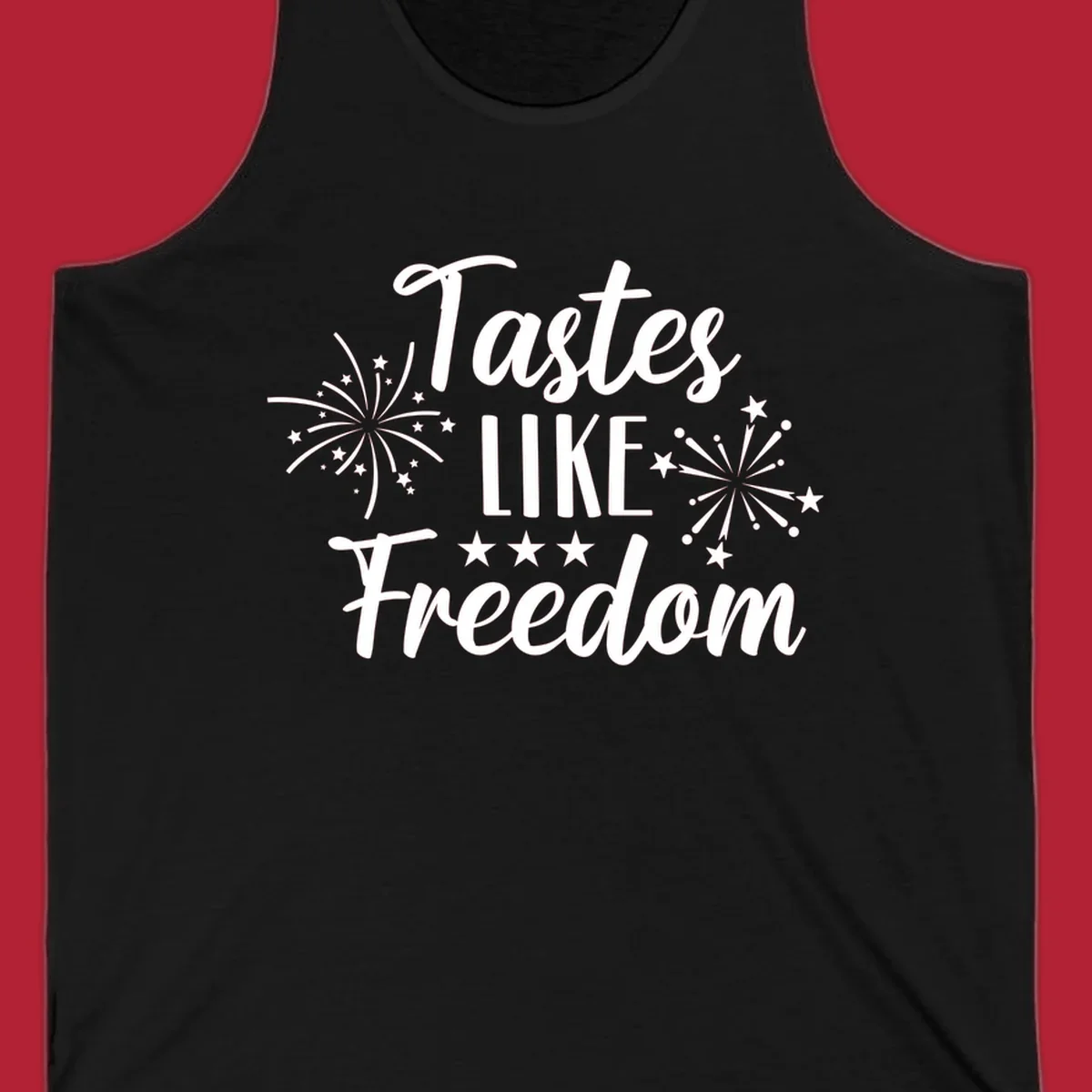 A patriotic design with the phrase 'Tastes LIKE Freedom' in script and block letters, surrounded by fireworks and stars.