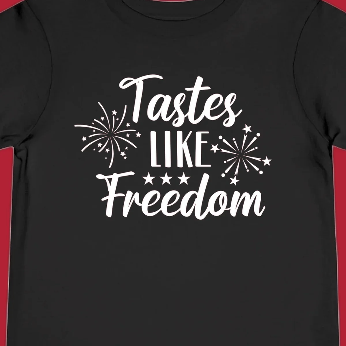 A patriotic design with the phrase 'Tastes LIKE Freedom' in script and block letters, surrounded by fireworks and stars.