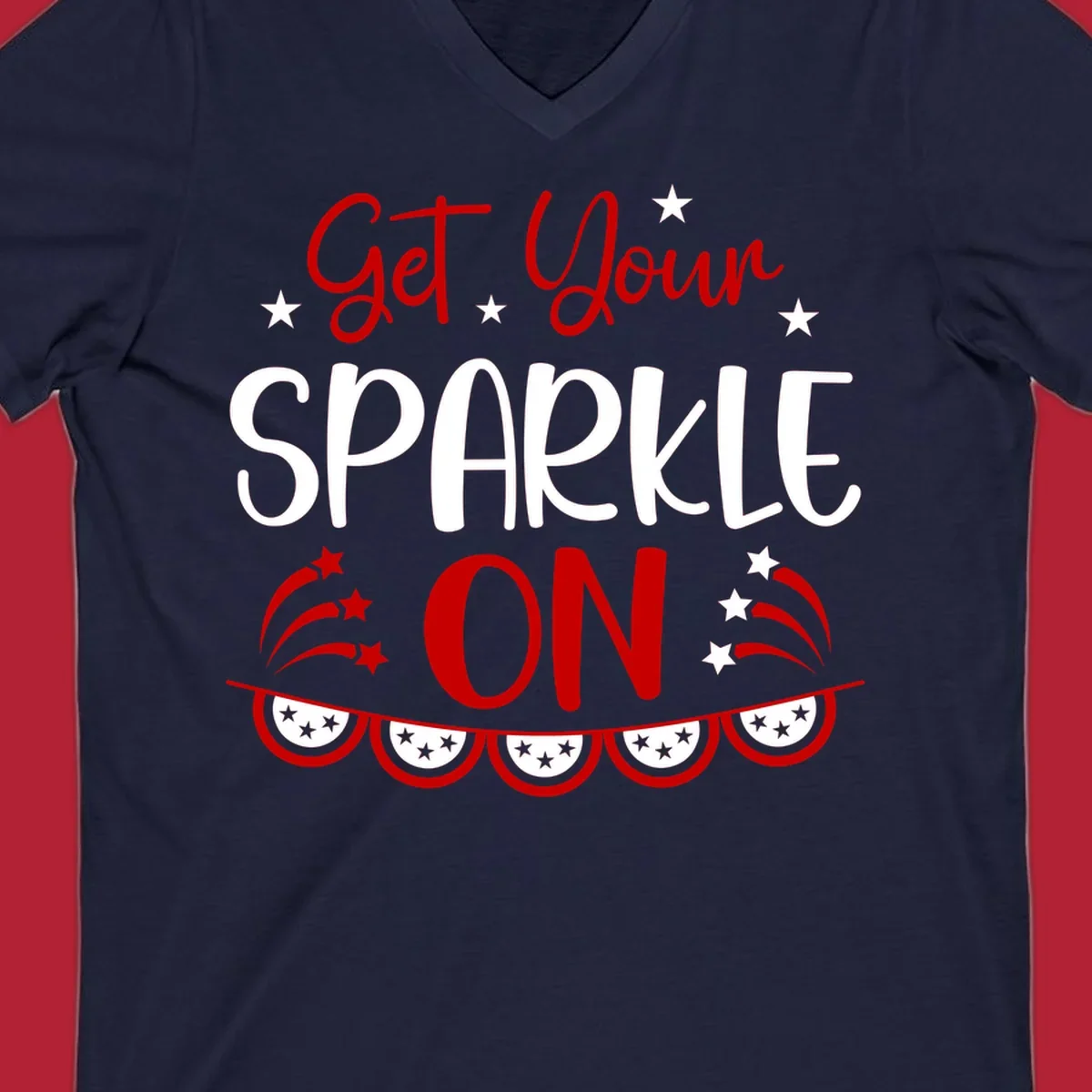 A patriotic design with the phrase 'Get Your SPARKLE ON' in red and blue, surrounded by white stars, fireworks, and bunting flags.