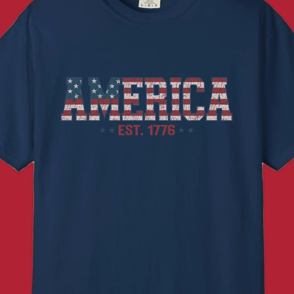 Distressed America Est. 1776 flag design with red, white, and blue flag pattern on block letters and stars.